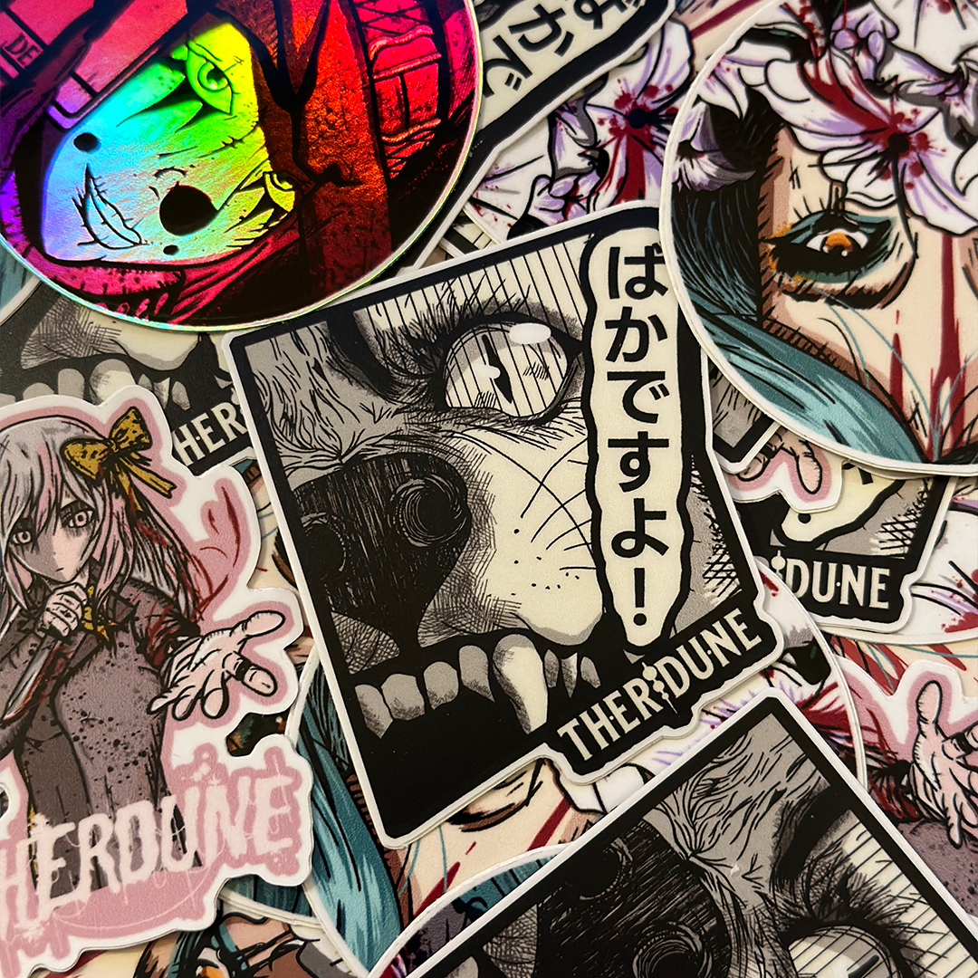 black and white manga style wolf, japanese characters that say "bakadesuyo" and an english Therdune logo on a pile of various stickers.