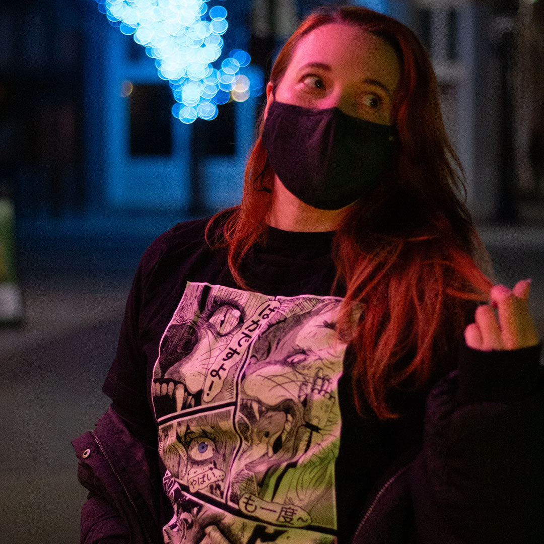 Black shirt with with 4 panel manga style illustration with japanese text and Therdune logo, worn by model, front view.