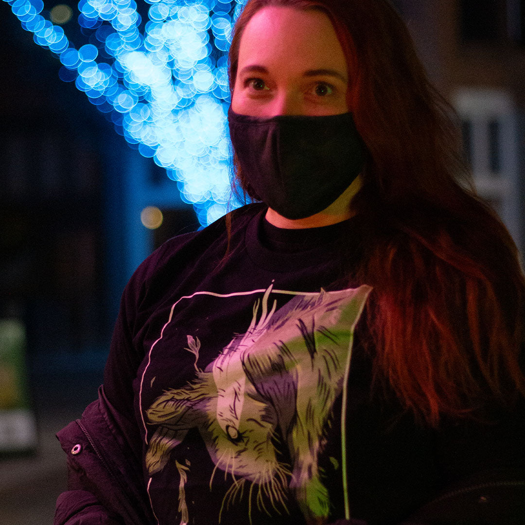 Black shirt with graphic of a falling rabbit, smokey tears coming out from the rabbit's eye. "Therdune" logo framed below. worn by model, outside at night.