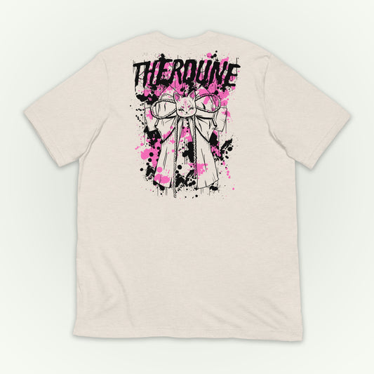 Back of cream color shirt with a graphic of a bow with pink and black paint splatter and a Therdune logo. flat lay on transparent background.
