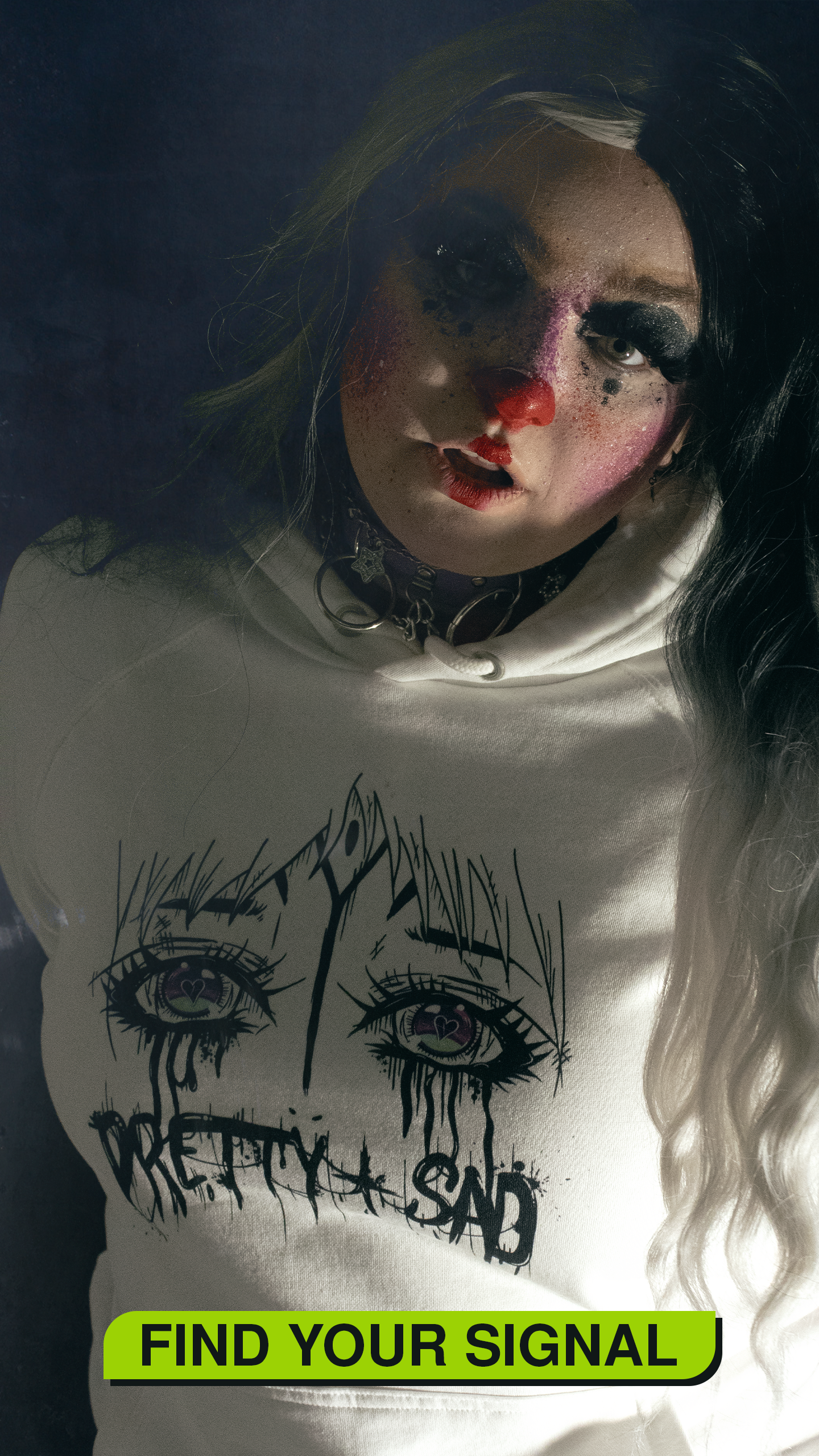 Person wearing a hoodie with eye design and text 'Pretty Sad' on a dark background. Button labelled "Find your signal" 