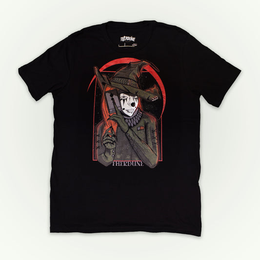 Black shirt with a graphic of a witch clown holding a tarrot card. flat lay on white background.