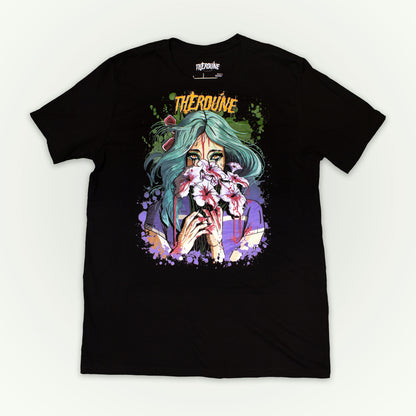 Black shirt with a stylized illustration of a person with teal hair and colorful makeup. Flat lay on white background.