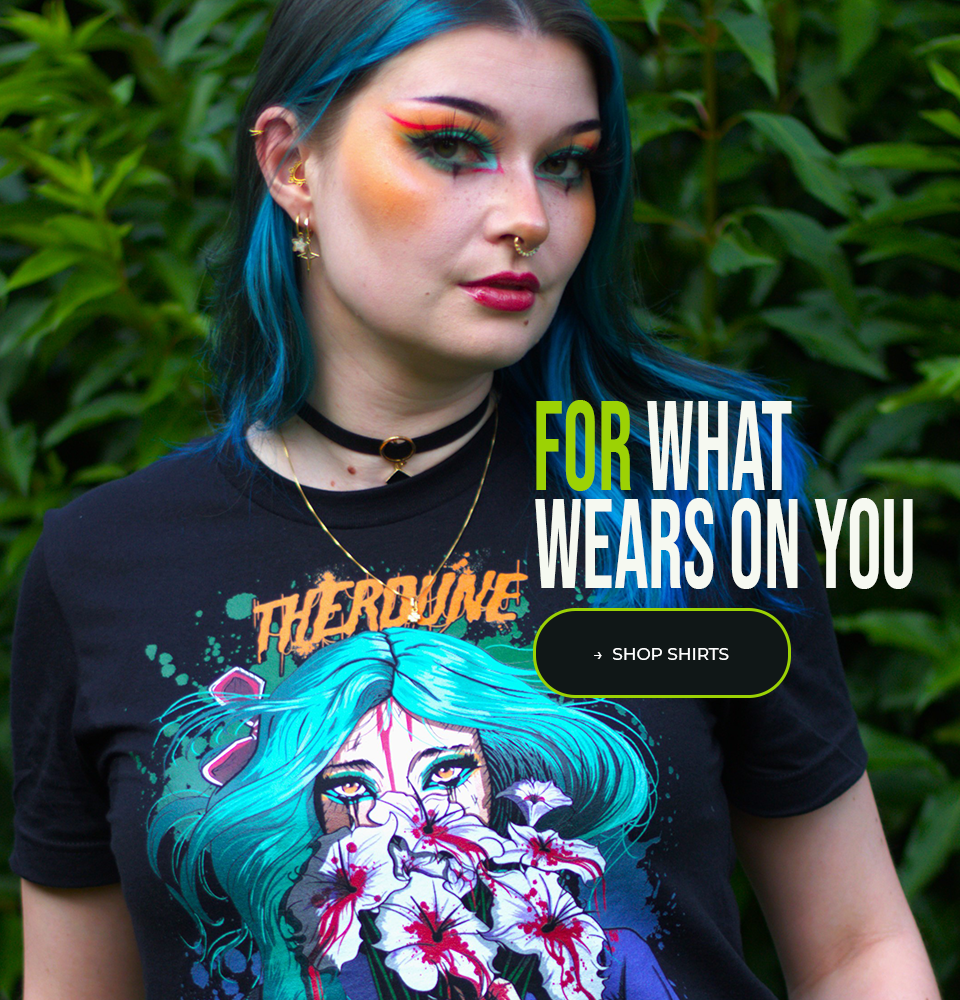 Person wearing a black t-shirt with a colorful graphic design, standing against a green leafy background. A caption reads "for what wears on you" with a button labelled "shop shirts" 