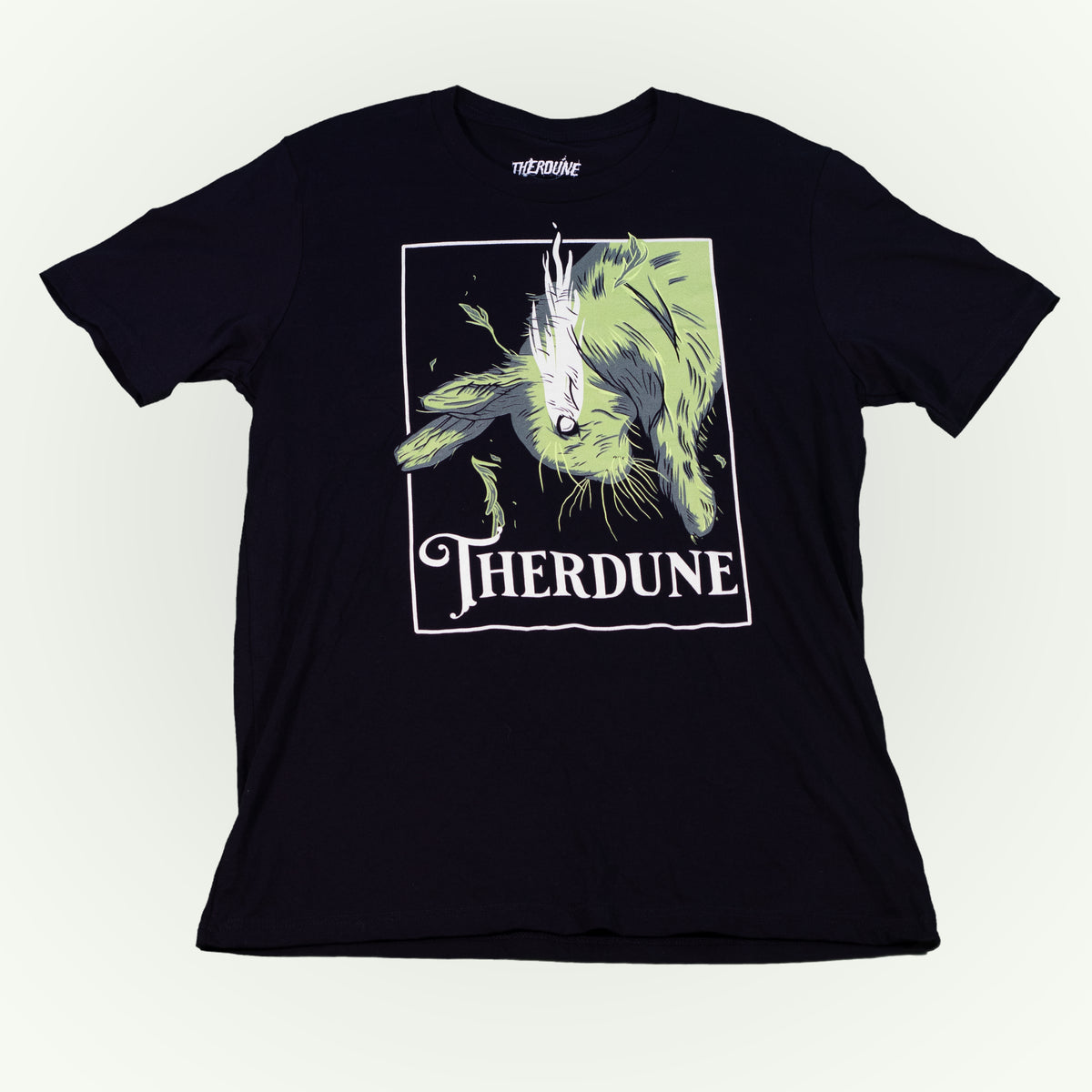 Black shirt with graphic of a falling rabbit, smokey tears coming out from the rabbit's eye. "Therdune" logo framed below. Flat lay on transparent background.