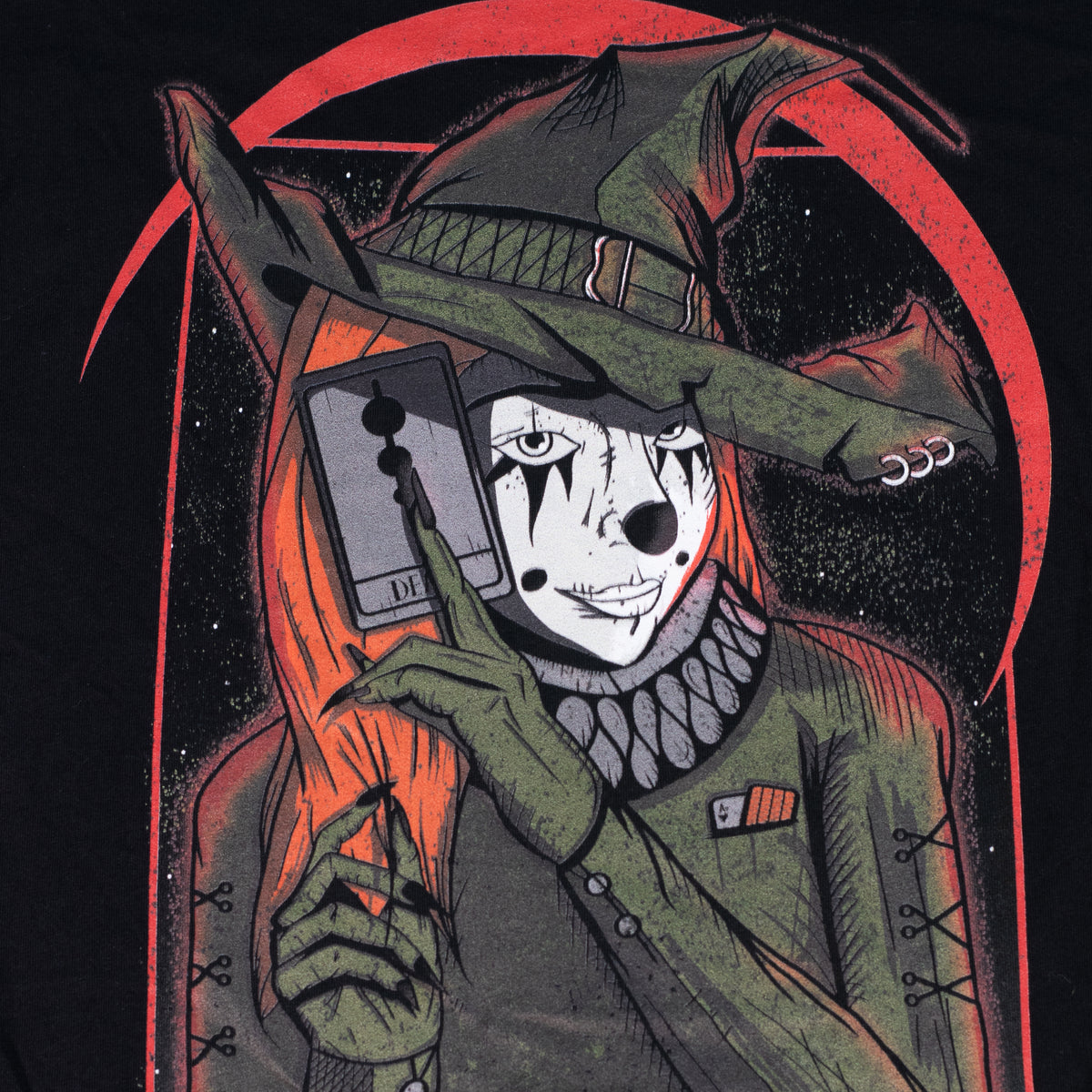 Black shirt with a graphic of a witch clown holding a tarrot card.