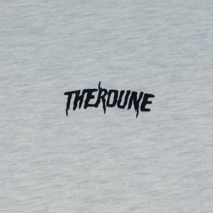 Close-up of an ash short-sleeve crewneck t-shirt laid flat. A black Therdune logo is printed on fabric.