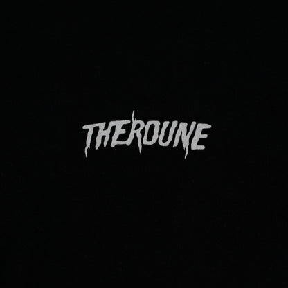 Close-up of a black short-sleeve crewneck t-shirt laid flat. A white Therdune logo is printed on fabric.