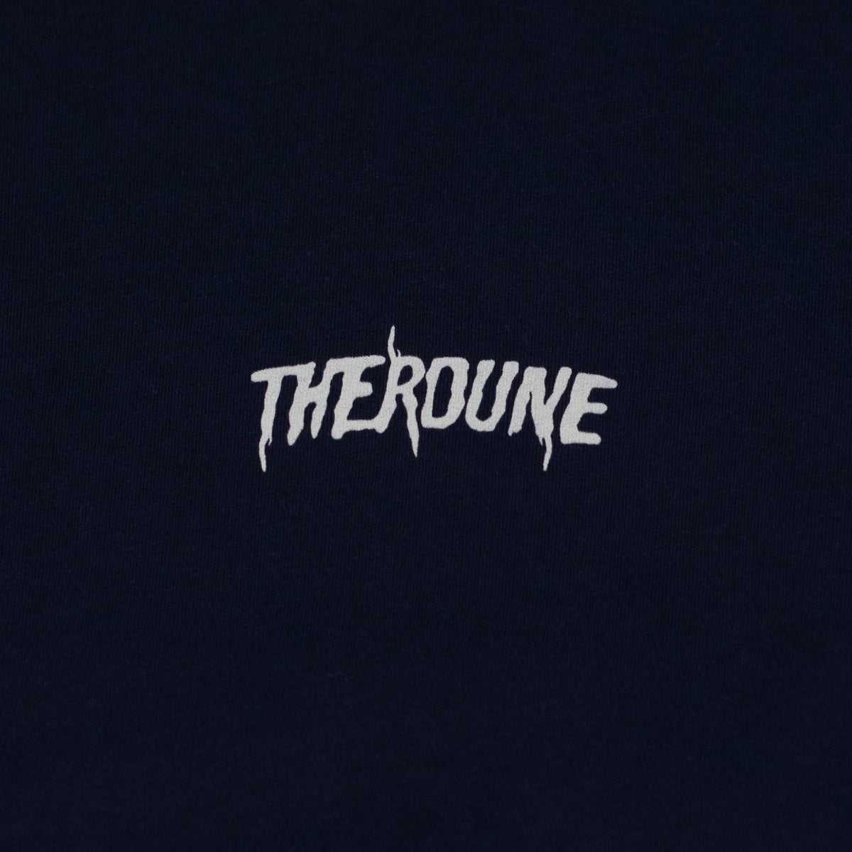 Close-up of a navy short-sleeve crewneck t-shirt laid flat. A white Therdune logo is printed on fabric.