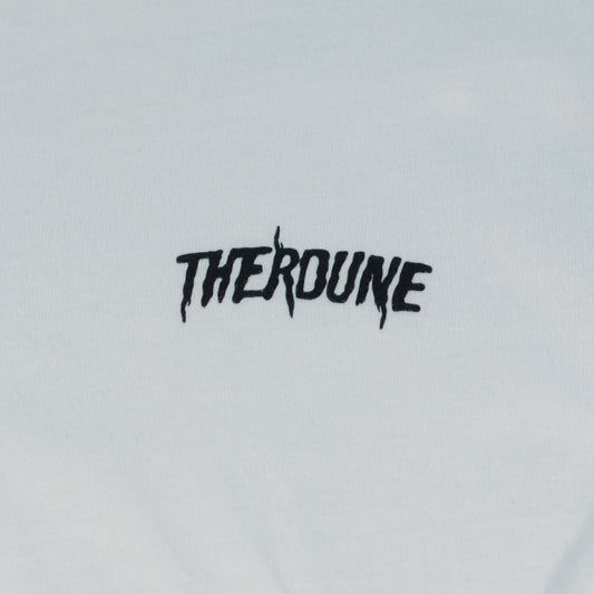 Close-up of a white short-sleeve crewneck t-shirt laid flat. A black Therdune logo is printed on fabric.
