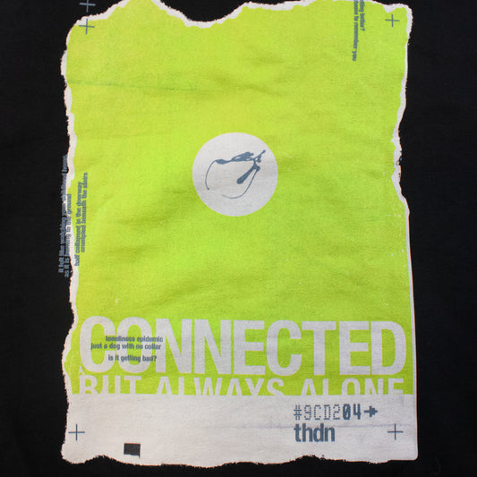 A bright lime green torn-paper poster or print with white text reading 'CONNECTED BUT ALWAYS ALONE,' a white circular logo near the top center, and smaller text including '#9CD204' and 'thdn,' shown against a black background.