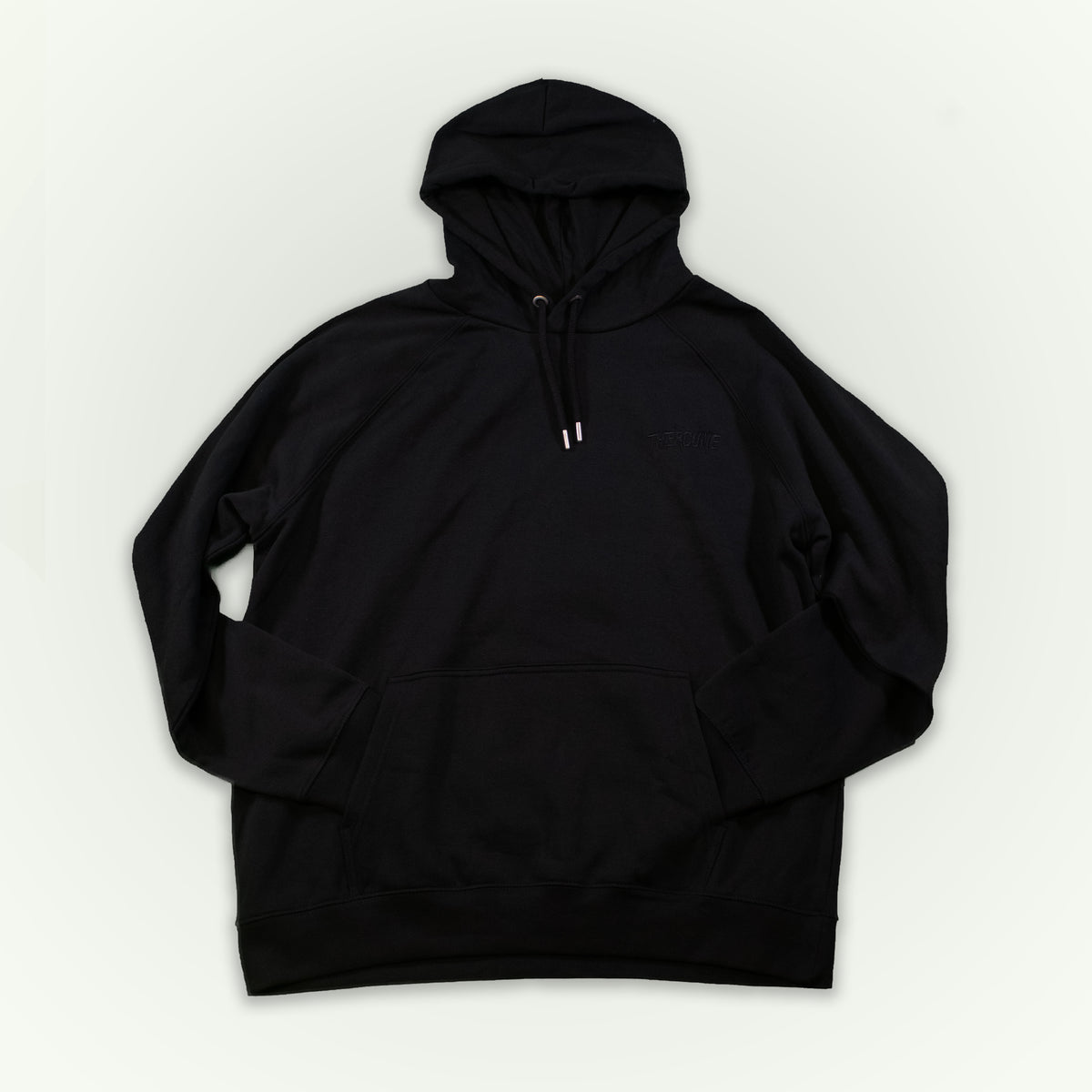 A black pullover hoodie with a drawstring hood and kangaroo pocket, laid flat against a light off-white background. A 'Therdune' logo is embroidered in black on the left chest. 