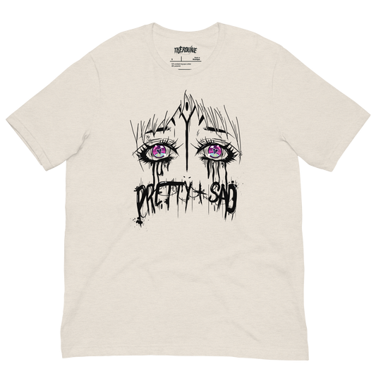 Cream color shirt with a graphic print of stylized eyes and the text 'Pretty & Sad' on the front. flat lay on transparent background.